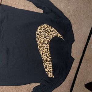 Nike leopard print check mark. Super cute nothing wrong with it. Two small stain